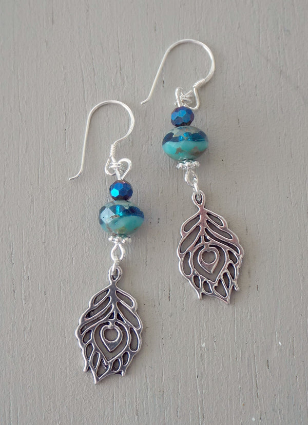 Earrings with peacock feathers, sea green rondelles & midnight minis
