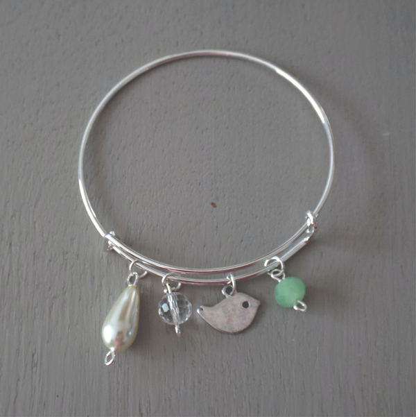 Adjustable silver plated bangle with birdie charm, ivory & green beads