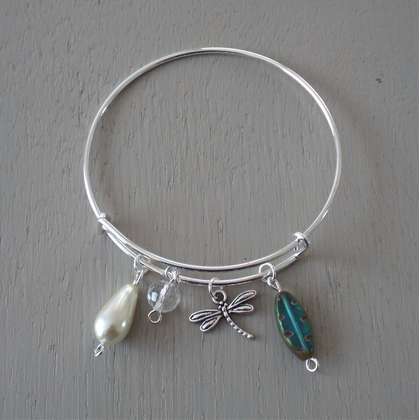 Adjustable silver plated bangle with dragonfly charm and blue green accent