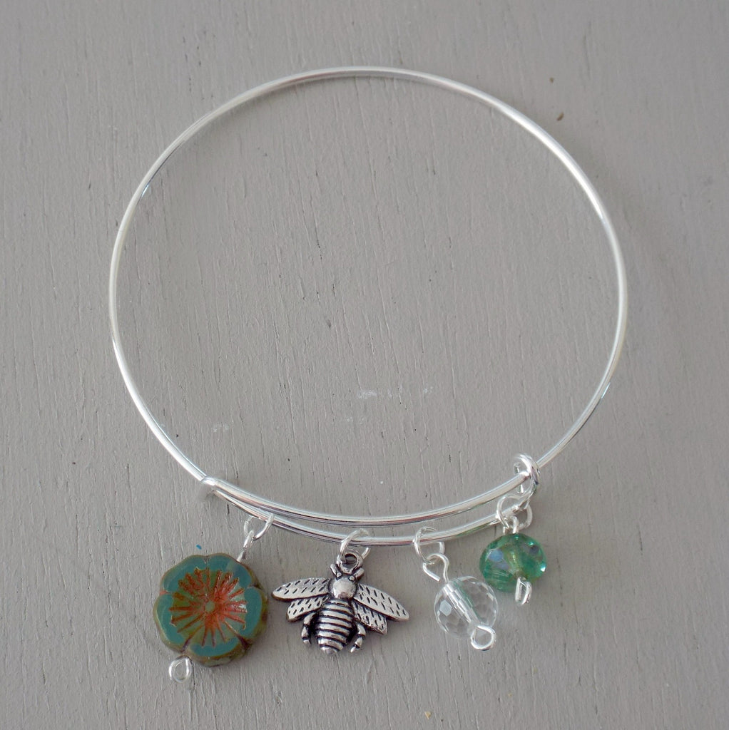 Adjustable bangle with silver plated bee charm, green beads