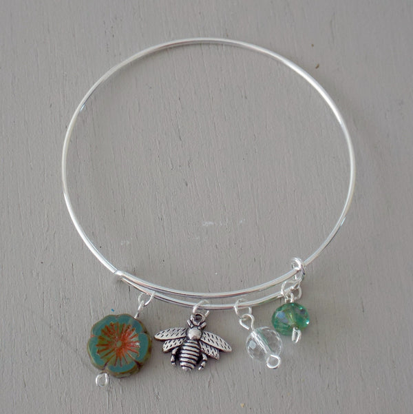 Adjustable bangle with silver plated bee charm, green beads