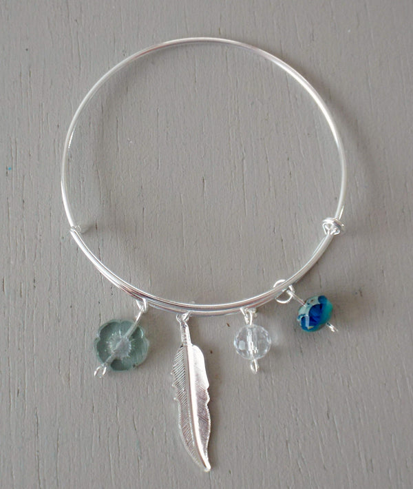 Adjustable bangle with bright silver plated feather charm & aqua / seagreen beads