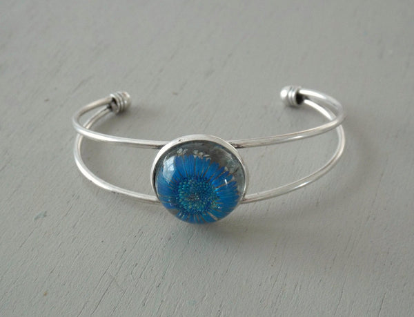 Solid silver plated open bangle with 20mm blue daisy