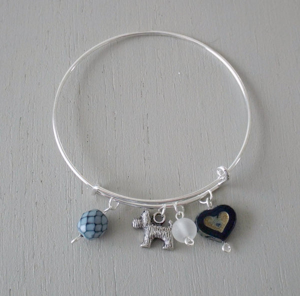 Adjustable sliver plated bangle with dog charm, blue accents