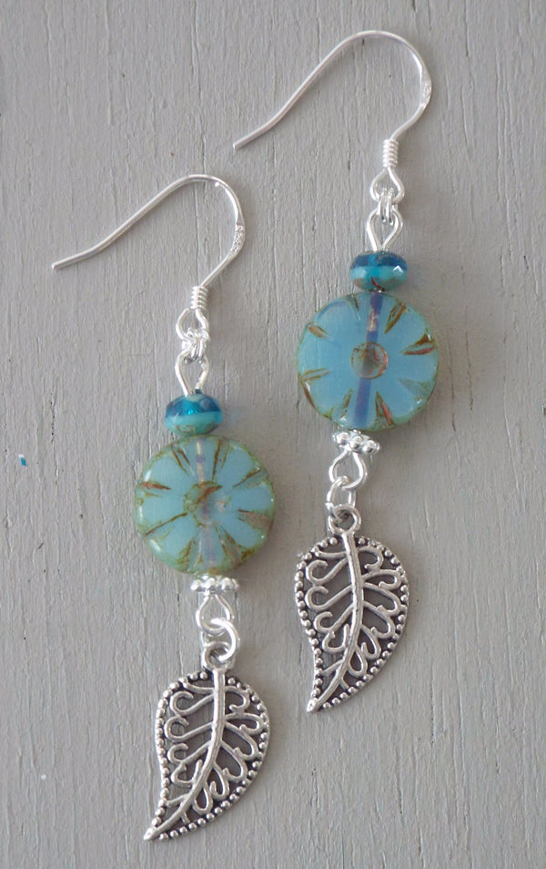 Earrings with silver plated filigree leaf charms, milky aqua wheels