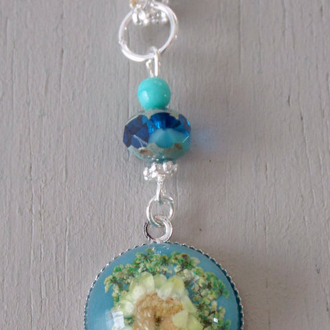 Pendant with 18mm blue & yellow floral focal, sea green accents