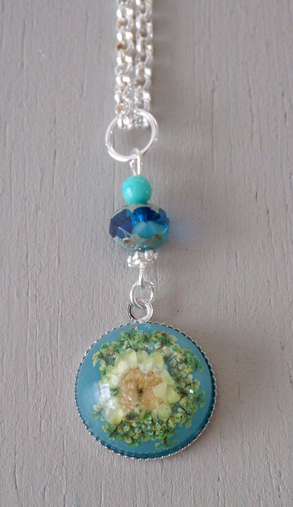 Pendant with 18mm blue & yellow floral focal, sea green accents