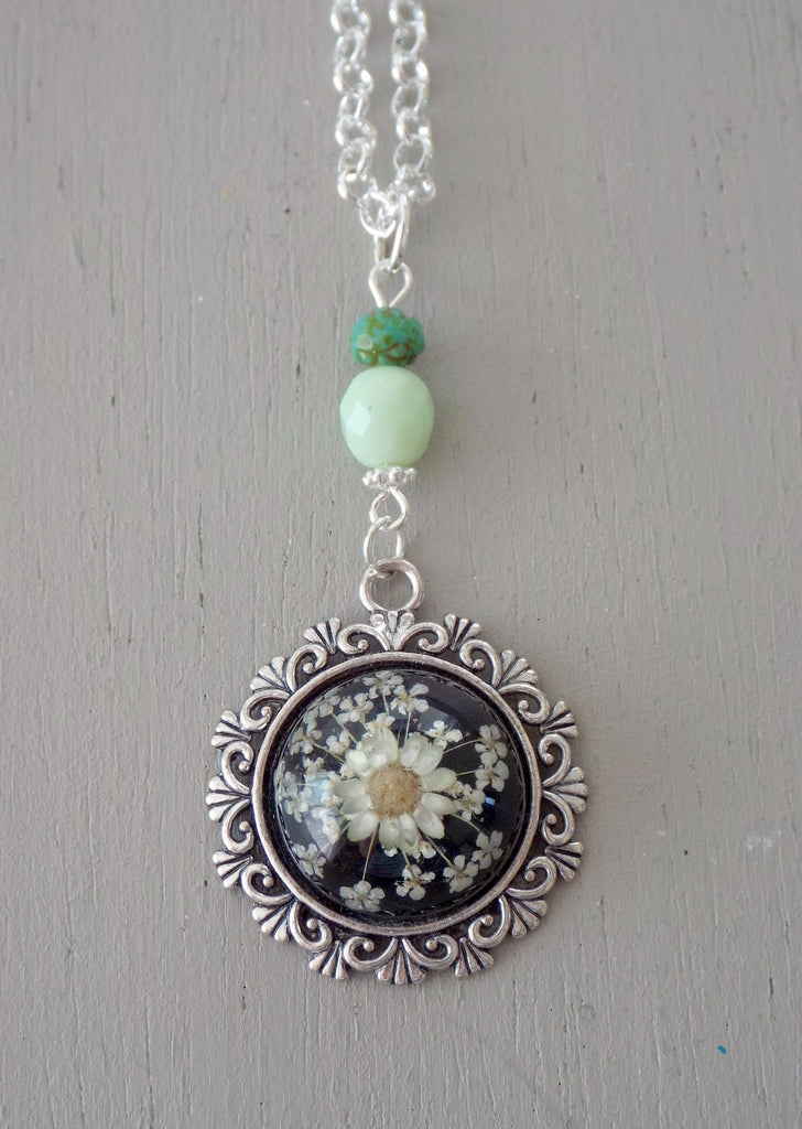 Pendant with 20mm black & yellow floral focal, ornate setting, mint & green beads