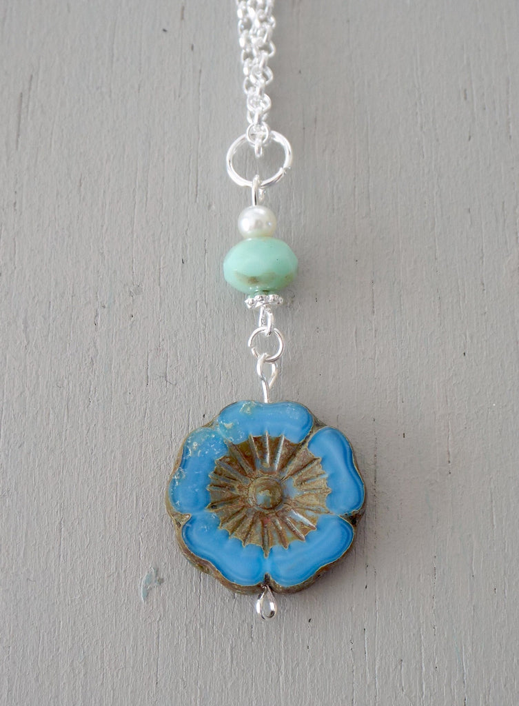 Pendant with 20mm blue carved floral disc, mint & ivory beads